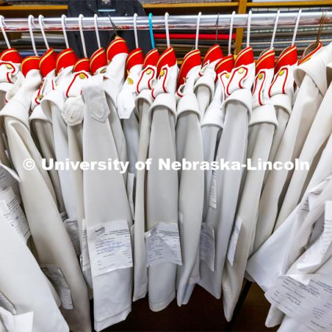 Altered band uniforms await pick up. Demetrios and Stamatia Delgiannis have been altering the Cornhusker Marching Band uniforms for 50 years from their Lincoln tailoring business. September 1, 2021. Photo by Craig Chandler / University Communication.