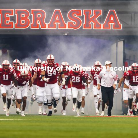 The Nebraska Football team run through a cloud of fog as they enter the field through the tunnel walk. Nebraska vs. Fordham University football game. September 4, 2021. Photo by Craig Chandler / University Communication.