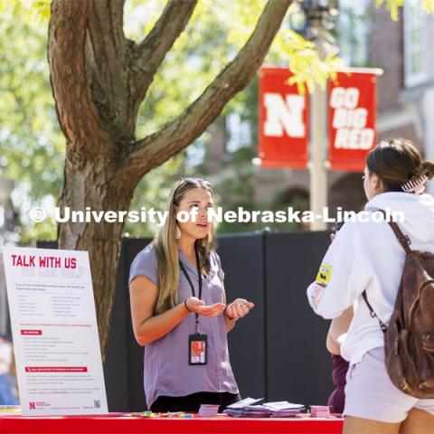 Mariah Petersen, a CAPS outreach coordinator talks with a student at the counseling and psychological services booth during the Campus Safety Awareness Fair outside the Nebraska Union. September 8, 2021. Photo by Craig Chandler / University Communication.