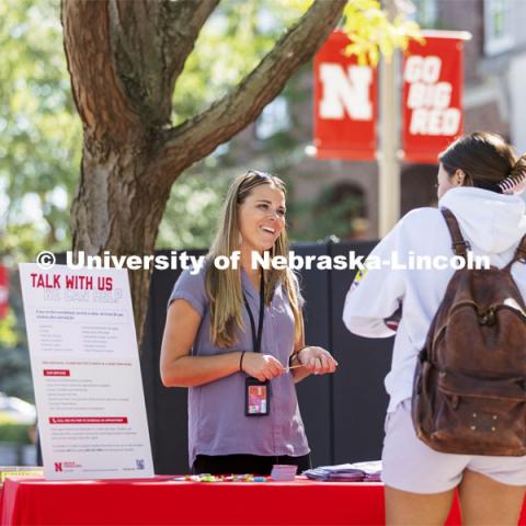 Mariah Petersen, a CAPS outreach coordinator talks with a student at the counseling and psychological services booth during the Campus Safety Awareness Fair outside the Nebraska Union. September 8, 2021. Photo by Craig Chandler / University Communication.