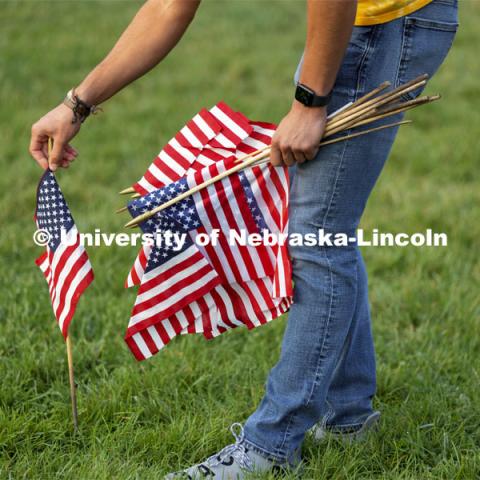 Students set out more than 100 flags in the green space north of the Nebraska Union to commemorate 9/11. 9/11 memorials. September 9, 2021. Photo by Craig Chandler / University Communication.