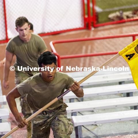 Army ROTC cadet Hsee Htoo carries the unit guidon up the steps. UNL ROTC cadets and Lincoln first responders run the steps of Memorial Stadium to honor those who died on 9/11.  Each cadet ran more than 2,000 steps. September 9, 2021. Photo by Craig Chandler / University Communication.