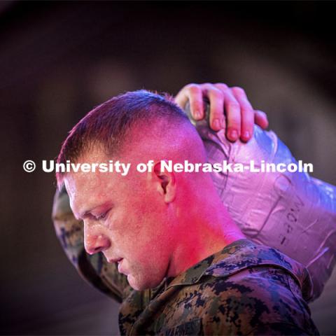 Staff Sargent Scott Johnson, an active-duty Marine who works with the NROTC program, carries a sandbag up and down the steps of the stadium. He said it weighed about 40 pounds. UNL ROTC cadets and Lincoln first responders run the steps of Memorial Stadium to honor those who died on 9/11. Each cadet ran more than 2,000 steps. September 9, 2021. Photo by Craig Chandler / University Communication.