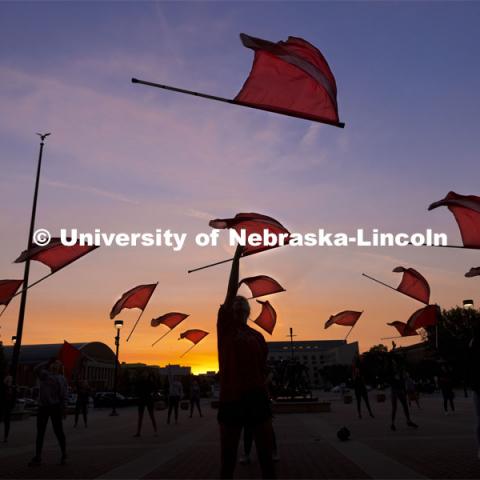 Cornhusker Marching Band Color Guard practices by dawn’s early light outside east stadium. September 9, 2021. Photo by Craig Chandler / University Communication.
