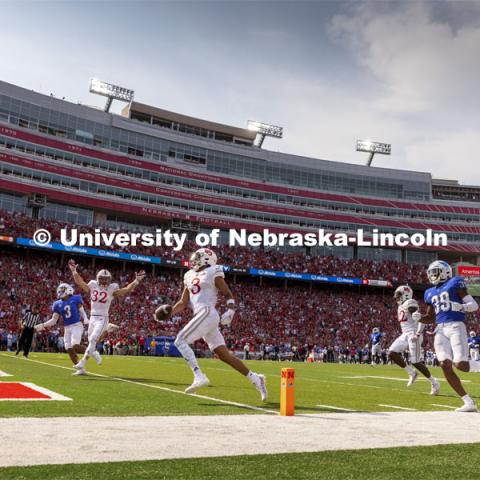 Nebraska players celebrate a touchdown. Nebraska vs. Buffalo University game on the 20th anniversary of 9/11. Photo by Craig Chandler / University Communication.