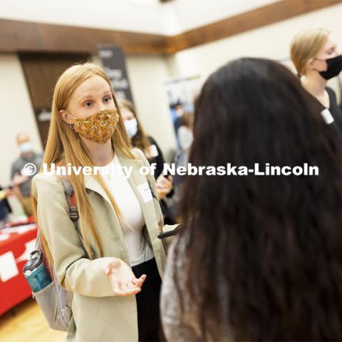 Jayme Soderbeck, a junior in management, talks with recruiters at Tuesday’s Career Fair.  Day 1’s career opportunities center around the following career pathways: Business, Management and Operations, Training, Government & Public Administration, Human Services & Non-profit, Law, Public Safety & Security, Health & Public Health.  September 21, 2021. Photo by Craig Chandler / University Communication