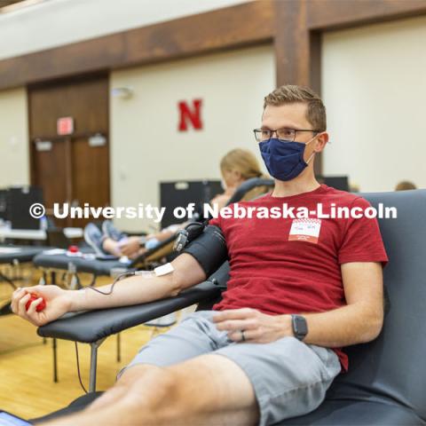 Tim Aulner, a masters student, from Omaha, donates Tuesday. Homecoming week blood drive in Nebraska Union. September 28, 2021. Photo by Craig Chandler / University Communication.