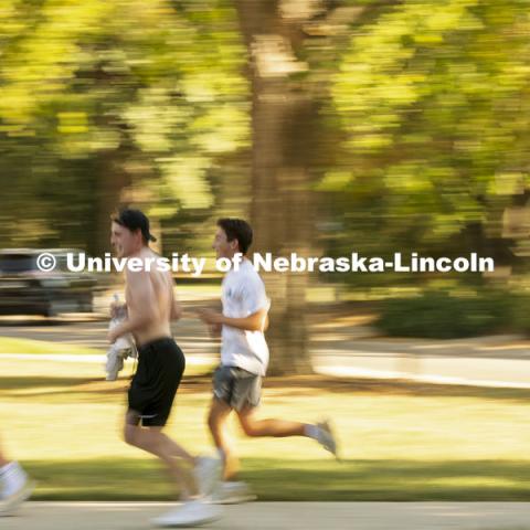 A team races from Perin Porch to the Dairy Store as part of the Homecoming Traditions Race. The Traditions Race will consist of clues leading to 10-15 traditions around campus, and the first three teams to find every tradition will be declared winners. September 28, 2021. Photo by Craig Chandler / University Communication.