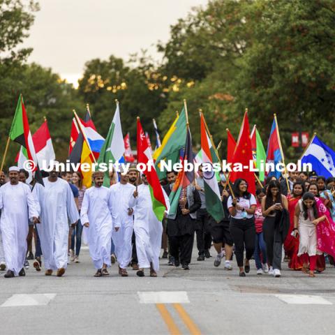 Approximately 100 international students carrying their country’s flags march the parade route. Homecoming Parade and Cornstalk Festival. October 1, 2021. Photo by Craig Chandler / University Communication.