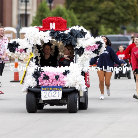 A golf cart decorated like a cow is part of the Homecoming Parade. Homecoming Parade and Cornstalk Festival. October 1, 2021. Photo by Craig Chandler / University Communication