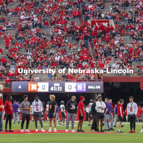 Husker recruits watch the pregame warmups from the field before the Nebraska vs Northwestern University homecoming game. October 2, 2021. Photo by Craig Chandler / University Communication.