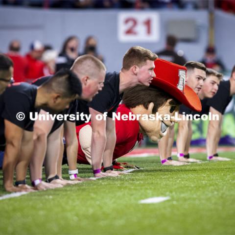 Herbie Husker participates with the ROTC Cadets in push-ups for points. Nebraska vs Northwestern University homecoming game. October 2, 2021. Photo by Craig Chandler / University Communication.