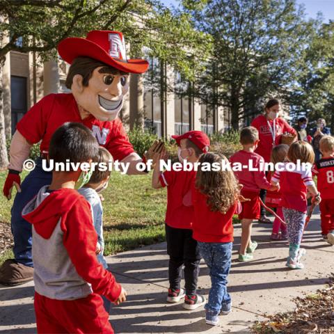 To celebrate Campus Childcare Centers Week at the Ruth Staples Child Development Lab, Herbie Husker, the children, teachers, sprit squad members and band members had a parade from the flagpole by Chase Hall to Ag Hall. October 4, 2021. Photo by Craig Chandler / University Communication.