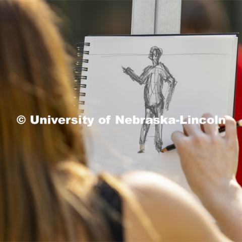 Ella Bartlett works on her drawing. On a great fall day outside Architecture Hall, Chip Stanley’s DSGN 120 - Design Drawing class drew each other at various sizes to work on depth drawing. October 5, 2021. Photo by Craig Chandler / University Communication.