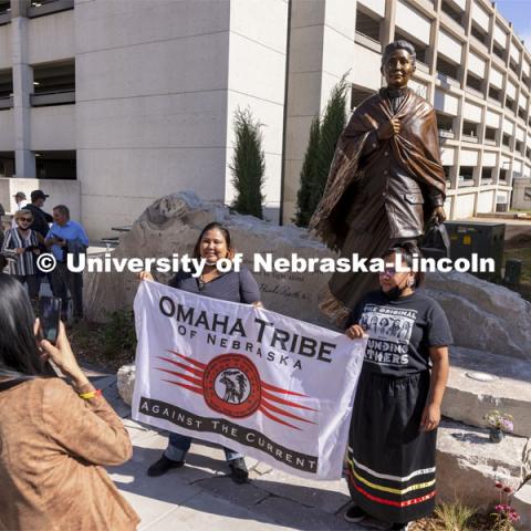 Members of the Omaha Tribe pose for photos with the sculpture of Dr. Susan LaFlesche Picotte, the first Indigenous person to receive a medical degree. Dedication ceremony of a sculpture of Dr. Susan LaFlesche Picotte, the first Indigenous person to receive a medical degree was held at Heritage Plaza on Centennial Mall. Dr. LaFlesche Picotte was a member of the Omaha tribe. The sculpture dedication was part of the State’s day-long celebration of Nebraska’s first Indigenous Peoples Day. October 11, 2021. Photo by Craig Chandler / University Communication.