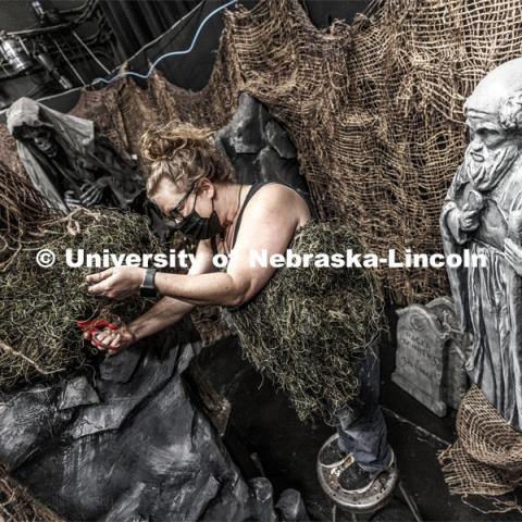 Production Designer Jill Hibbard works on the scenery in amongst the statuary. The Nebraska Repertory Theatre has turned Howell Theatre’s stage and backstage into a haunted house with a Shakespeare twist. ShakesFEAR opens October 15 and runs through Halloween. October 12, 2021. Photo by Craig Chandler / University Communication.