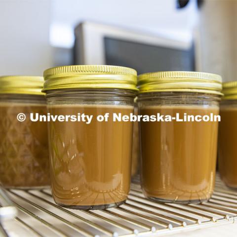 Students working in the product development lab at the Food Innovation Center help test new flavors and changing ingredients for corporate clients. A batch of flavored coffees await further testing.  October 13, 2021. Photo by Craig Chandler / University Communication.