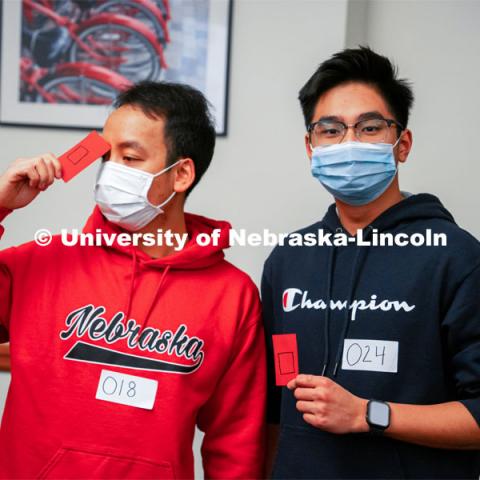 Hung Bui, left, and Hieu Luu hold their cards which put them on the square team for Capture the Bacon. Vietnamese Student Association (Recognized Student Organization) plays their own version of Squid Games during their meeting. October 21, 2021. Photo by Jonah Tran / University Communication.