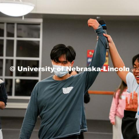 Nam Vo has his arm lifted by Justin Pham after Vo won the Squid Games. Pham made the games and hosted the event. Vietnamese Student Association (Recognized Student Organization) plays their own version of Squid Games during their meeting. October 21, 2021. Photo by Jonah Tran / University Communication.