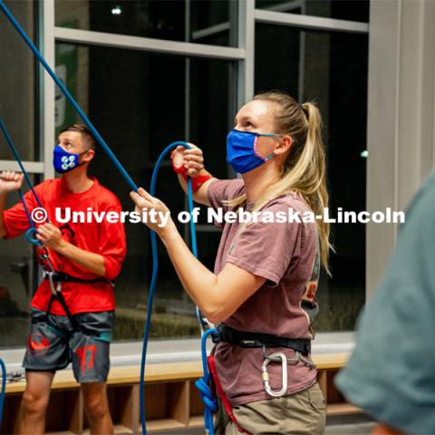 Students participate in the lead climbing clinic during the first night of a two-night clinic learning the basics of lead climbing on the on-campus rock wall. October 26, 2021. Photo by Jonah Tran / University Communication.