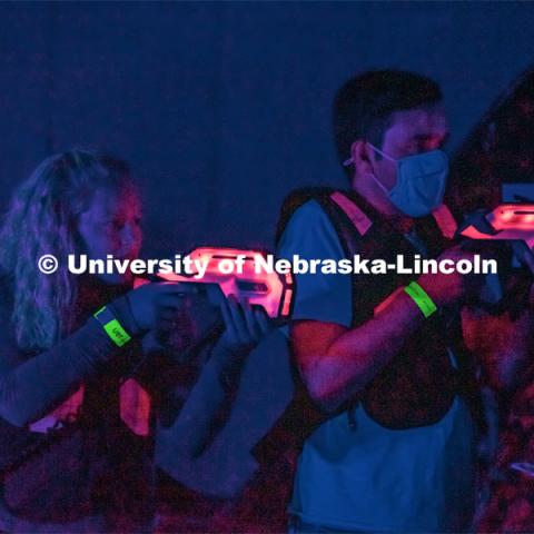 Students at Nightmare at East Campus. Students enjoy a fun-tastic night of indoor Halloween-themed activities and treats in the Nebraska East Union. Students wore costumes to participate in a costume contest, laser tag, pumpkin painting, bowling and a hayrack ride. October 28, 2021. Photo by Jonah Tran / University Communication. 