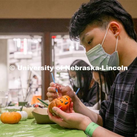 Students at Nightmare at East Campus. Students enjoy a fun-tastic night of indoor Halloween-themed activities and treats in the Nebraska East Union. Students wore costumes to participate in a costume contest, laser tag, pumpkin painting, bowling and a hayrack ride. October 28, 2021. Photo by Jonah Tran / University Communication. 