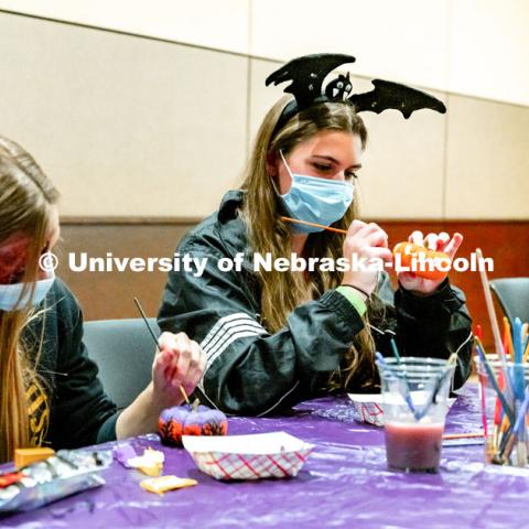 Students at Nightmare at East Campus. Students enjoy a fun-tastic night of indoor Halloween-themed activities and treats in the Nebraska East Union. Students wore costumes to participate in a costume contest, laser tag, pumpkin painting, bowling and a hayrack ride. October 28, 2021. Photo by Jonah Tran / University Communication. 