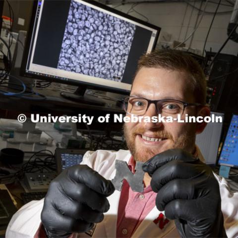 Eric Markvicka, Assistant Professor in Mechanical and Materials Engineering, holds a rubber-like “N” embedded with liquid metal droplets that themselves contain glass microparticles, Markvicka's team has improved the material's thermal conductivity while retaining its natural pliability. That could make the approach useful in engineering wearable technologies and soft robotics that can shed the excess heat produced by their microelectronics — reducing the risk of overheating — while remaining lightweight and elastic enough for practical use. November 4, 2021. Photo by Craig Chandler / University Communication