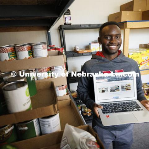 Gabin Kundwa helped Connection Point's food bank keep track of its clients by writing software that replaced handwritten note cards. November 16, 2021. Photo by Craig Chandler / University Communication.