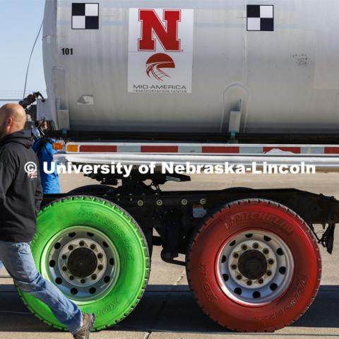 Each of the rigs tires were painted a different color so researchers could plot where on the barrier each wheel came into contact with it when it hit during the test. Researchers from the Midwest Roadside Safety Facility conducted a rare tractor-tanker crash to test how a newly designed and significantly less tall concrete roadside barrier performs in a crash. The test was at the facility’s Outdoor Proving Grounds on the western edge of the Lincoln Municipal Airport. December 8, 2021. Photo by Craig Chandler / University Communication.