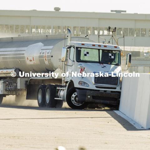 The roadside barrier developed by University of Nebraska–Lincoln researchers holds firm as a fully-loaded tractor-tanker vehicle slams into it during a Dec. 8 test. Researchers from the Midwest Roadside Safety Facility conducted a rare tractor-tanker crash to test how a newly designed and significantly less tall concrete roadside barrier performs in a crash. The test was at the facility’s Outdoor Proving Grounds on the western edge of the Lincoln Municipal Airport. December 8, 2021. Photo by Craig Chandler / University Communication.