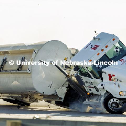 The roadside barrier developed by University of Nebraska–Lincoln researchers holds firm as a fully-loaded tractor-tanker vehicle slams into it during a Dec. 8 test. Researchers from the Midwest Roadside Safety Facility conducted a rare tractor-tanker crash to test how a newly designed and significantly less tall concrete roadside barrier performs in a crash. The test was at the facility’s Outdoor Proving Grounds on the western edge of the Lincoln Municipal Airport. December 8, 2021. Photo by Craig Chandler / University Communication.