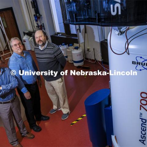 CIBC Directors Jiantao Guo, Robert Powers and Jean-Jack Riethoven pose with the Nuclear Magnetic Resonance spectroscope in Hamilton Hall. Support for Nebraska’s Center for Integrated Biomolecular Communication has been renewed for five more years, as the center continues to position the university as a national leader in the critical area of biomedical research.

CIBC was created in 2016 as a National Institutes of Health Center of Biomedical Research Excellence, or COBRE. A nearly $10.7 million Phase 2 grant will fund the center through 2026.

The center is focused on investigating cellular level miscommunications that contribute to diseases such as cancer, diabetes and chronic liver disease. It fosters a systems approach, combining the research expertise of chemists, biochemists, engineers and bioinformaticists and connects researchers developing new molecular probes and analytical techniques with those unraveling molecular mechanisms of diseases. December 9, 2021. Photo by Craig Chandler / University Communication.