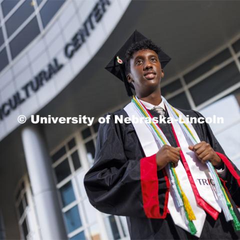 Khalid Yusuf, who served as a Diversity Ambassador, stands in his graduation regalia near the Gaughan Multicultural Center. He is graduating this December with a degree in Psychology. December 14, 2021. Photo by Craig Chandler / University Communication.