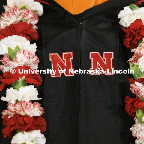 John Farag added color to his regalia with a red and white lei. Graduate Commencement at Pinnacle Bank Arena. December 17, 2021. Photo by Craig Chandler / University Communication.