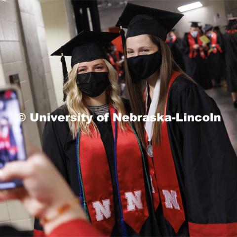 Kaylee Radicia and Lauren von Freiberg are photographed by a friend before the ceremony. Undergraduate Commencement at Pinnacle Bank Arena. December 18, 2021. Photo by Craig Chandler / University Communication.