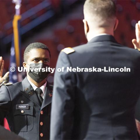 Hunter Parker takes oath of office as he was commissioned as a second lieutenant in the U. S. Army from Colonel Thad Fineran of Nebraska National Guard during commencement. Undergraduate Commencement at Pinnacle Bank Arena. December 18, 2021. Photo by Craig Chandler / University Communication.
