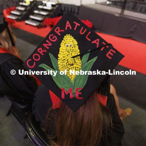 Sarah Burke gave her mortar board a corny look. Decorated mortarboards at the Undergraduate Commencement at Pinnacle Bank Arena. December 18, 2021. Photo by Craig Chandler / University Communication.