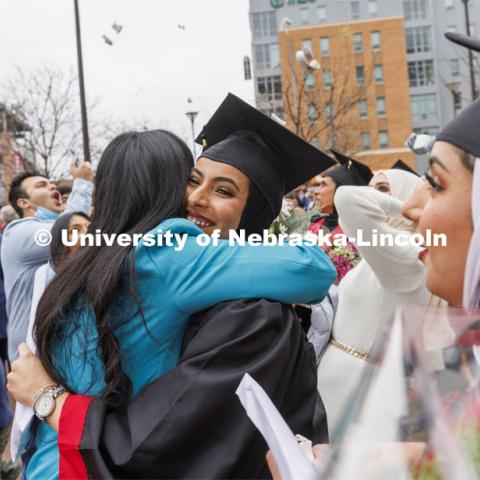 Maathar Said Abdul Rahman Al Balushi celebrates her business degree after the ceremony. Undergraduate Commencement at Pinnacle Bank Arena. December 18, 2021. Photo by Craig Chandler / University Communication.