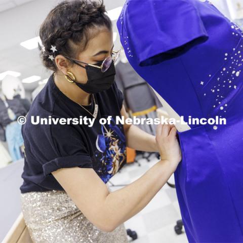 Adria Sanchez-Chaidez, a graduate student in Textiles, Merchandising and Fashion Design, pins her Star Trek-inspired dress, “Boldly Go”, one of her geek couture designs, onto a mannequin. January 21, 2022. Photo by Craig Chandler / University Communication.