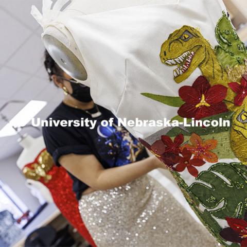 Adria Sanchez-Chaidez, a graduate student in Textiles, Merchandising and Fashion Design, pins “Destination Isla Nublar”, one of her geek couture designs, onto a mannequin. January 21, 2022. Photo by Craig Chandler / University Communication.