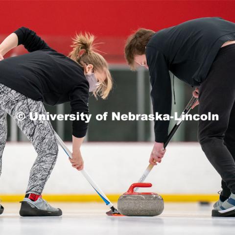 Emma Whaley (left) and Seamus Hurley (right) during curling practice at the John Breslow Ice Hockey Center. Curling Club. February 1, 2022. Photo by Jordan Opp for University Communication.
