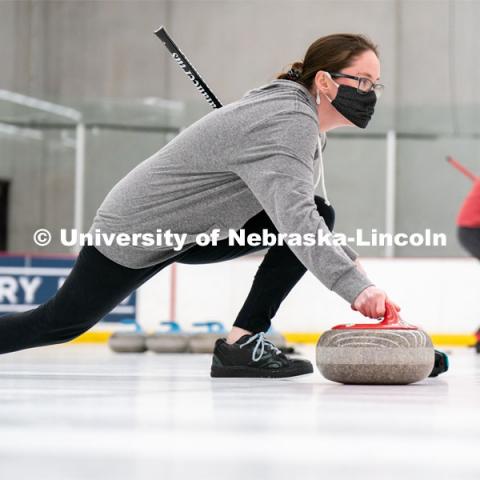 Kylee Hauxwell serves during curling practice at the John Breslow Ice Hockey Center. Curling Club. February 1, 2022. Photo by Jordan Opp for University Communication.