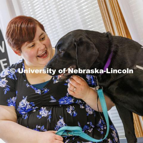 Liz Higley, a 2019 Animal Science grad and owner of Uplifting Paws, poses with Freddie, a service dog she is training. February 2, 2022. Photo by Craig Chandler / University Communication.
