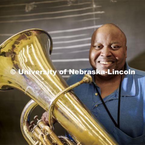 Kabin Thomas is a non-traditional doctoral student in music, specifically tuba performance. He’s able to pursue his doctorate through a fellowship that receives support from Glow Big Red. Thomas is photographed with his tuba in the Glenn Korff School of Music. February 7, 2022. Photo by Craig Chandler / University Communication.