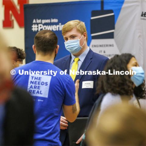 Luke Buettner talks with a Nelnet recruiter at the UNL Spring Career Fair in the Nebraska Union. February 15, 2022. Photo by Craig Chandler / University Communication.