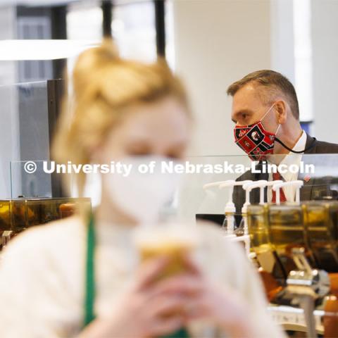 Chancellor Ronnie Green waits for his coffee at the Nebraska East Union Starbucks. Chancellor Green provided free drip coffee from Starbucks on City and East campuses in celebration of Glow Big Red. February 16, 2022. Photo by Craig Chandler / University Communication.