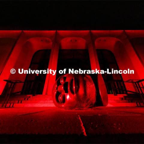 The Sheldon Memorial Art Gallery and Fallen Dreamer sculpture are bathed in red lights for Glow Big Red. February 16, 2022. Photo by Craig Chandler / University Communication.