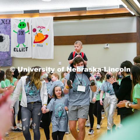 Miracle Family members who attend the marathon run through a cheering tunnel of students to start the marathon. University of Nebraska–Lincoln students exceeded their goal, raising over $230,000 during the annual HuskerThon on Feb. 26. Also known as Dance Marathon, the event is part of a nationwide fundraiser supporting Children’s Miracle Network Hospitals. The annual event, which launched in 2006, is the largest student philanthropic event on campus. The mission of the event encourages participants to, “dance for those who can’t.” All funds collected by the Huskers benefit the Children’s Hospital and Medical Center in Omaha. February 26, 2022. Photo by Jonah Tran / University Communication.



