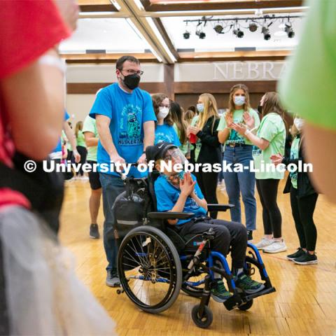 Miracle Family members who attend the marathon run through a cheering tunnel of students to start the marathon. University of Nebraska–Lincoln students exceeded their goal, raising over $230,000 during the annual HuskerThon on Feb. 26. Also known as Dance Marathon, the event is part of a nationwide fundraiser supporting Children’s Miracle Network Hospitals. The annual event, which launched in 2006, is the largest student philanthropic event on campus. The mission of the event encourages participants to, “dance for those who can’t.” All funds collected by the Huskers benefit the Children’s Hospital and Medical Center in Omaha. February 26, 2022. Photo by Jonah Tran / University Communication.



